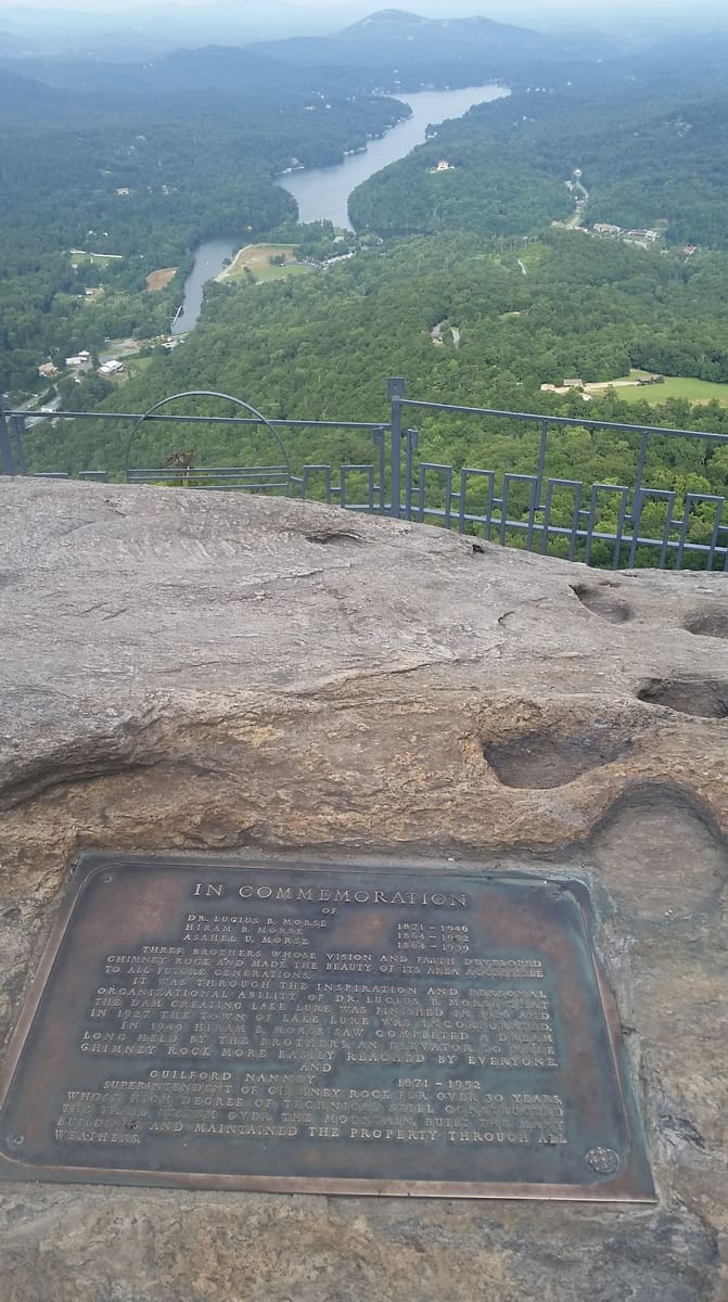 Chimney Rock Plaque with view of mountains and river further below