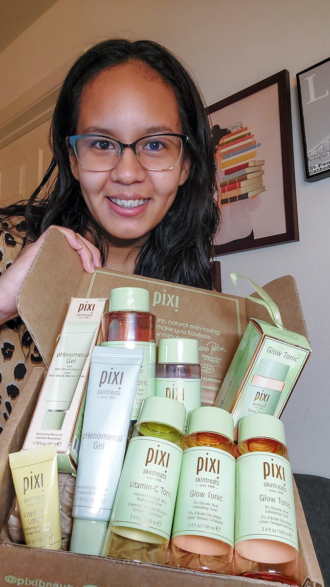 Yasmin holding up a box of Pixi Beauty tonic bottles and other skincare bottles | The Yasmin Diaries