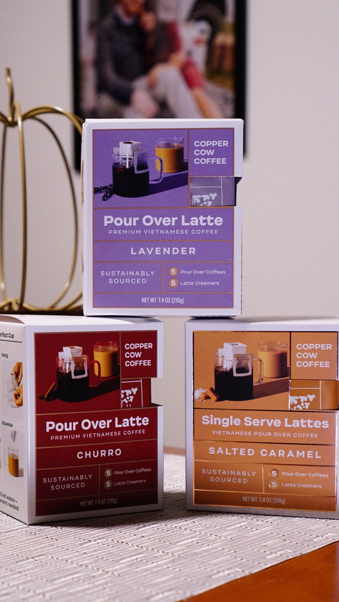 Picture of three Copper Cow Coffee flavor boxes, stacked. These coffees only require hot water and are perfect to keep at your work desk or to use when traveling.