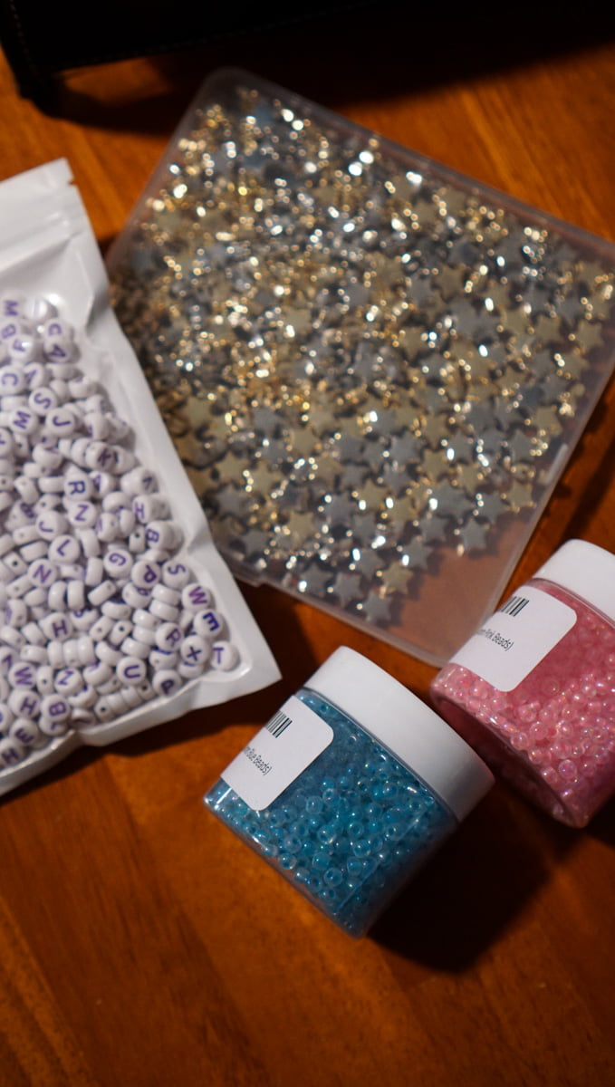 Beads that I will be using to make friendship bracelets for Taylor Swift's concert. Beads are star shaped, and there's also pink and blue beads.